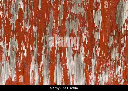 an old red peeling painted wood wall Stock Photo