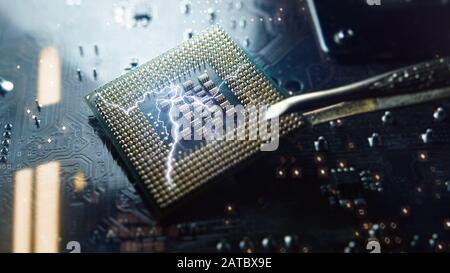 CPU central prosecution unit with the contacts facing up lying on the motherboard of the PC. The chip is electric effect with blue light. Technology b Stock Photo
