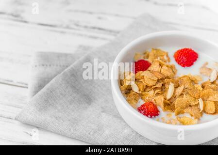 Bowl of breakfast cereals with milk and strawberries. Stock Photo