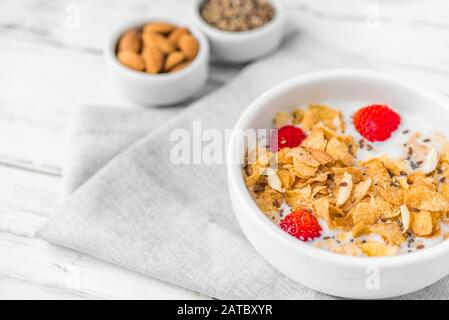 Bowl of breakfast cereals with milk and strawberries. Stock Photo