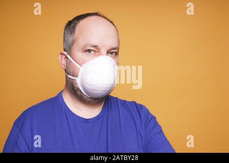person with face mask or dust mask or filtering facepiece respirator or breathing protection - virus outbreak or air pollution concept Stock Photo