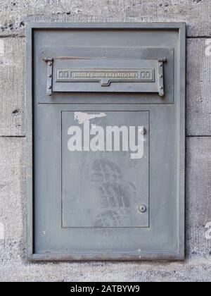 Old Dirty Metal Mailbox With Writing Letters And Newspapers In German Language Stock Photo