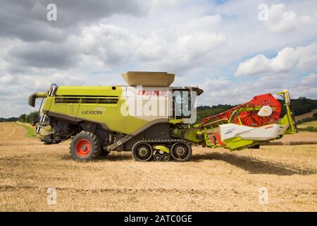 Combine Harvester harvesting on a summers day. Much Hadham, Hertfordshire. UK Stock Photo