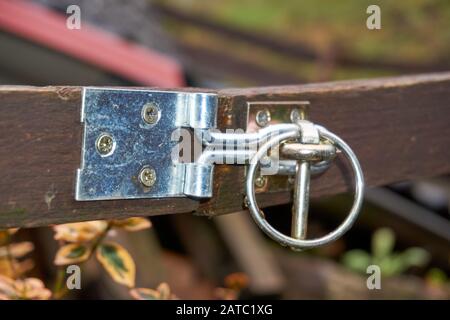 a slide latch on a wooden door photographed. Stock Photo