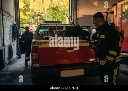 Fire engine truck parked inside the garage of the fire department Stock Photo