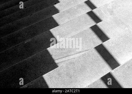 Concrete steps and shadows pattern, abstract in black & white of shadows on concrete steps. Stock Photo