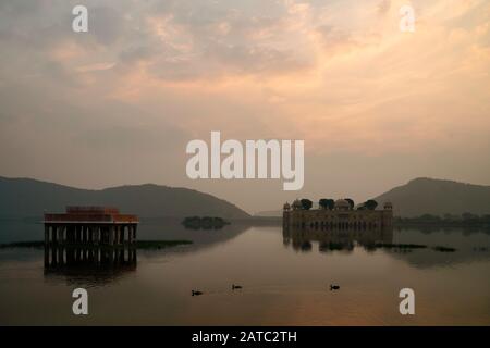 Empty Royal palace surrounded by lake and Aravalli hills as backdrop at daybreak in Jaipur, Rajasthan, India. Stock Photo