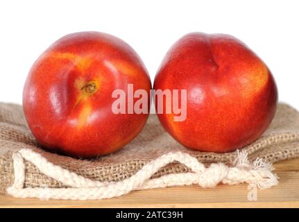 Two Apricots on burlap at market Stock Photo