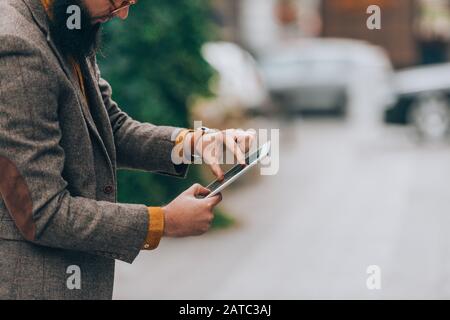 Modern day young businessman checking his e-mail on a tablet computer Stock Photo