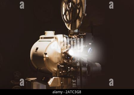 Vintage movie, cinema and movie reel projector on dark background. Stock Photo