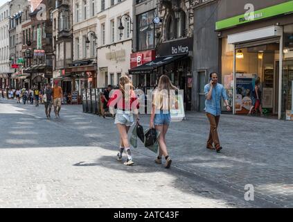 Brussels Old Town / Belgium - 06 25 2019: Teenage fashionable girls in summer clothes walking down the shopping streets around the  Anspach Avenue Stock Photo