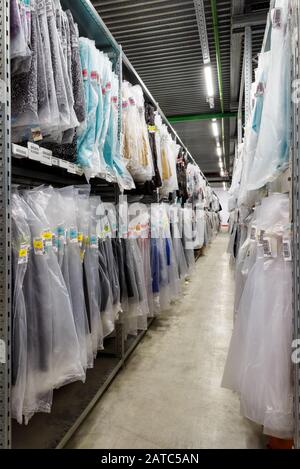 Moscow - March 18, 2016: Clothes are hanging in the large warehouse. Moscow is a modern city with well-developed logistics infrastructure.