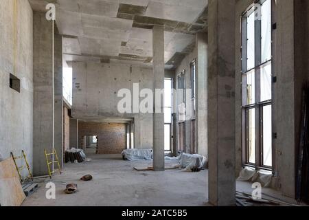 Construction of large building. Inside the modern construction site. Contemporary structure under construction with concrete walls, pillars, ceiling a Stock Photo