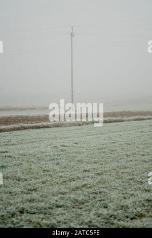 Power transmission line during winter season in a sunny day Stock Photo ...