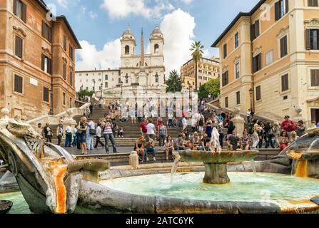 ROME - CIRCA OCTOBER 2012: The Spanish Steps, seen from Spanish square (Piazza di Spagna). Fountain of the Ugly Boat by Bernini in the foreground. The Stock Photo