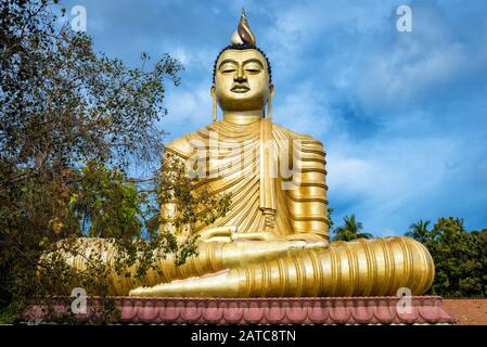 Buddha in the Wewurukannala Vihara old temple in the town of Dickwella, Sri Lanka. A 50m-high seated Buddha big statue is the largest in Sri Lanka. Hi Stock Photo