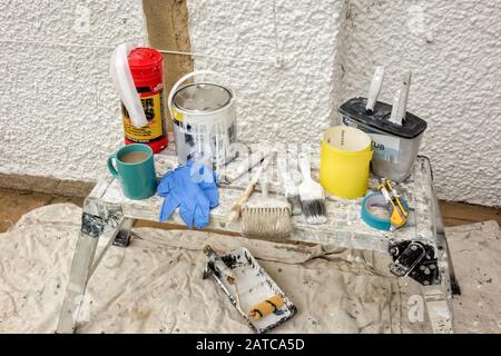 House painters tools sat on a small, aluminium workbench Stock Photo