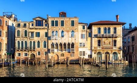 Vintage houses, Venice, Italy. Front view of facades of residential buildings on Grand Canal. Panorama of embankment in the Venice city center in summ Stock Photo