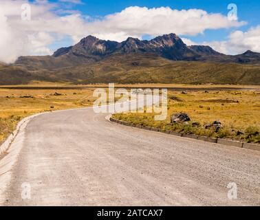 Stunning landscape with winding dirt road leading to Cotopaxi National Park, Ecuador Stock Photo