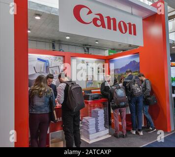 KYIV, UKRAINE - APRIL 06, 2019: People visit Canon booth at CEE 2019, the largest electronics trade show of Ukraine in Tetra Pack EC. Stock Photo