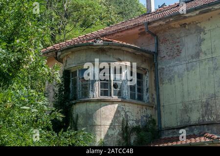Old obsolete industrial building facade with broken windows Stock Photo