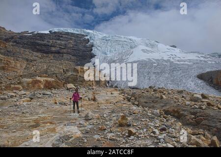 Trekker in front of Ritacuba Blanca and its massive glacier, El Cocuy National Park, Boyaca, Colombia Stock Photo