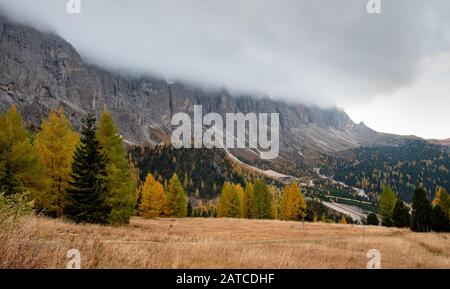 Mountain peaks of Langkofel or Saslonch, mountain range in the dolomites covered with fog during sunrise in South Tyrol, Italy Stock Photo