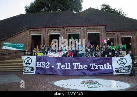 Uxbridge, UK. 1 February, 2020. Environmental activists from Stop HS2, Save the Colne Valley and Extinction Rebellion campaigning against the controversial HS2 high-speed rail link stand outside the London Borough of Hillingdon Civic Centre in Uxbridge during a ‘Still Standing for the Trees’ march from the Harvil Road wildlife protection camp in Harefield through Denham Country Park to three addresses closely linked to Boris Johnson in his Uxbridge constituency. The Prime Minister is expected to make a decision imminently as to whether to proceed with the high-speed rail line. Credit: Mark Ker Stock Photo