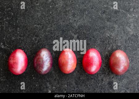 Easter eggs in marbled colours on a subtle anthracite background Stock Photo
