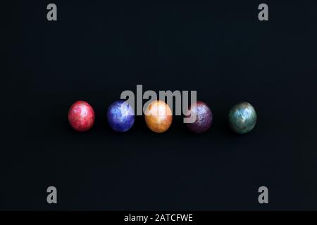 colourful marbled eggs on black background Stock Photo