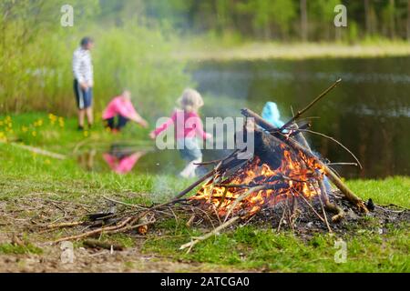 Forest bonfire. Having fun at a camp site with family and friends. Fun activities in summer. Stock Photo