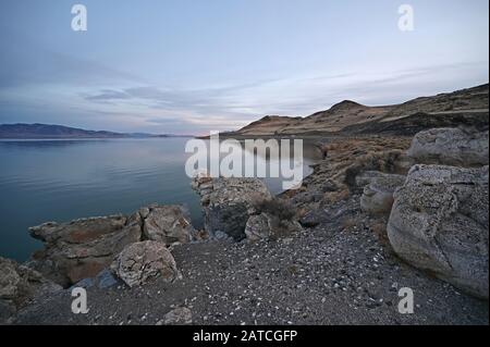 Rock formations and reflections of Pyramid Lake, Nevada on clear tranquil winter afternoon. Stock Photo
