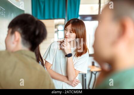 Group of students working on the mathematical problem Stock Photo