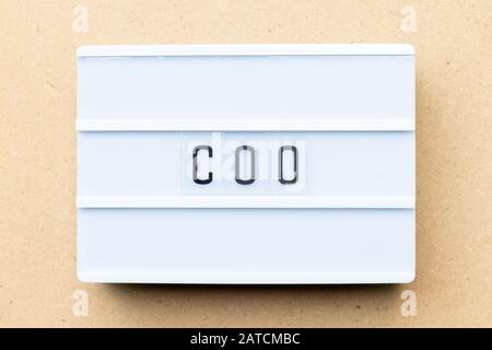 White lightbox with word COO (abbreviation Chief operating officer) on wood background Stock Photo