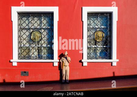 Peruvian military man, policeman standing in front of Puno Courthouse, Palacio de Justicia, Puno, Peru Stock Photo