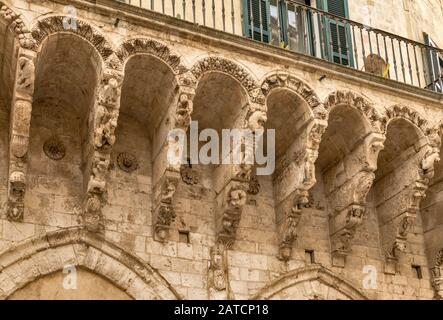Carved corbels at balcony, Loggia Balsamo, 14th century, in Brindisi, Apulia, Italy Stock Photo