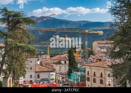 Construction cranes over center of L'Aquila, getting rebuilt after 2009 earthquake, 2018 view, L'Aquila, Abruzzo, Italy Stock Photo