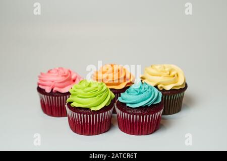 Red velvet cupcakes decorated with pastels Stock Photo