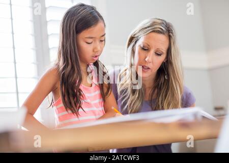 Teacher Helping Her Student With Her Homework Stock Photo