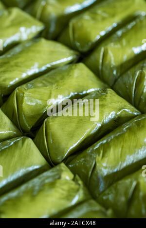 Glutinous rice steamed in banana leaf Khao Tom Mat or Khao Tom Pad food background Stock Photo