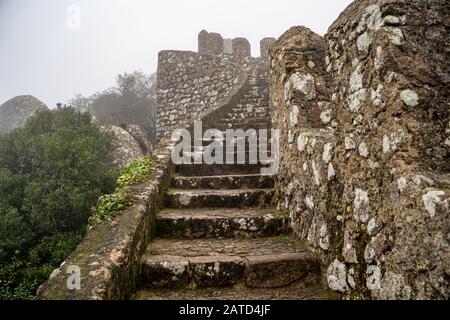 Steps leading up to the highest point at the ruins of the Moorish Castle, in the fog Stock Photo