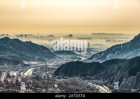 View on smog over Bejing in China from the top of thee Great Chinese Wall in the mountains near Bejing. Stock Photo