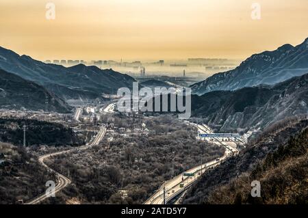 View on smog over Bejing in China from the top of thee Great Chinese Wall in the mountains near Bejing. Stock Photo