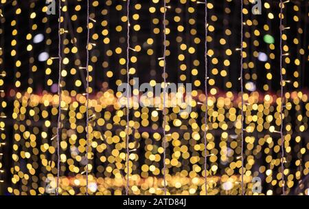 string of light bulbs on yellow abstract background Stock Photo