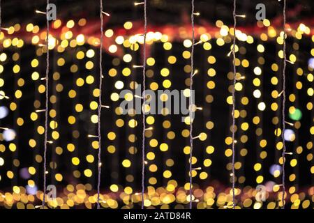 string of light bulbs on yellow abstract background Stock Photo