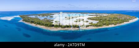 A remote tropical island in the Molucca Sea is fringed by mangrove forest surrounding a shallow lagoon. This island sits amid the Coral Triangle. Stock Photo