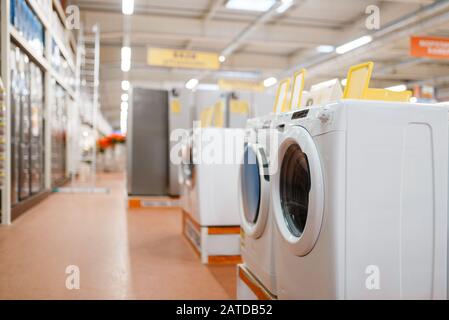 New washing machines in electronics store, nobody Stock Photo