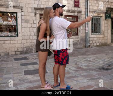 Montenegro, Sep 16, 2019: Young couple taking a selfie at the street in Kotor Old Town Stock Photo