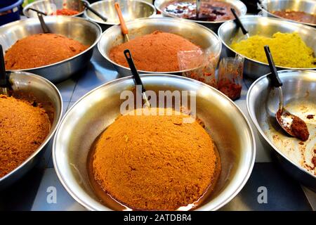 High angle view of several large bowls of Thai chili paste, Nam Prik Pao in a street market in Bangkok, Thailand Stock Photo
