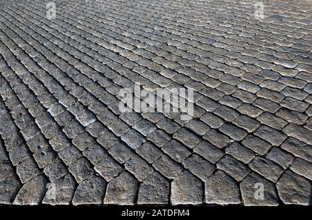 Unique pavement in a street of grey stones. Cobbled road close-up; texture; background Stock Photo